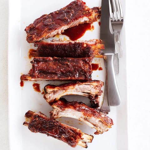 Oven-baked BBQ Ribs coated in smoky paprika rub, glistening with honey barbecue glaze and ready to serve.