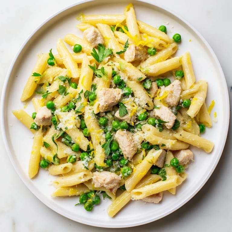 A vibrant spring-inspired Pea & Mint Chicken Pasta with golden chicken and peas in a creamy lemon sauce.