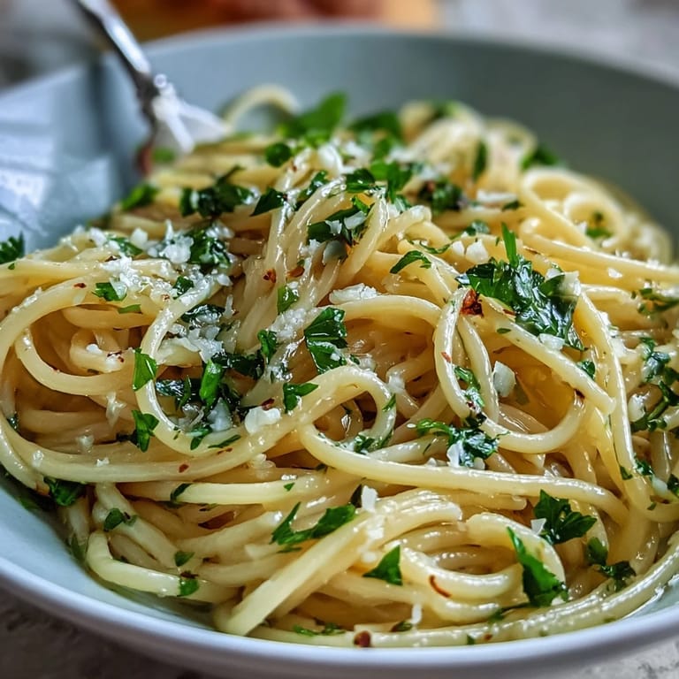 Silky lemon butter pasta with al dente spaghetti, garnished with parsley and extra Parmesan for a restaurant-style finish.