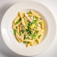 Penne pasta tossed with tender chicken, sweet peas, and fresh mint in a bright, zesty lemon sauce.